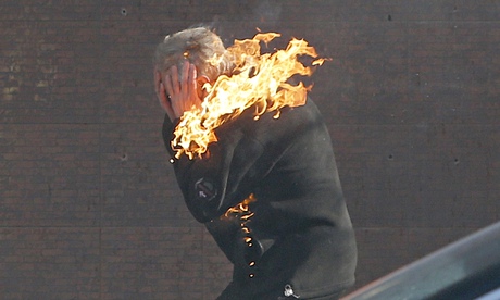 An anti-government protester is engulfed in flames