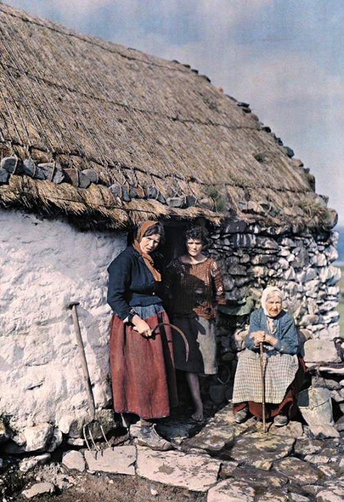 Three generations of peasant women stand outside their stone cottage in Ireland, 1927