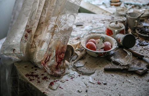 Damaged goods lie on a kitchen table in a house in Donetsk, Ukraine